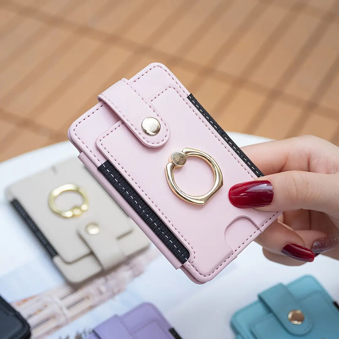 Pink leather card holder with black trim featuring a gold-colored universal ring small grip viewed from the front.