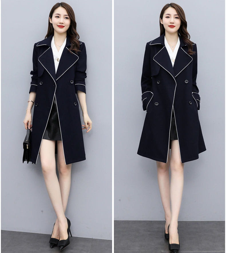 Women double breasted trench coat in navy blue with white contrast stitching and black buttons designed for stylish outerwear.