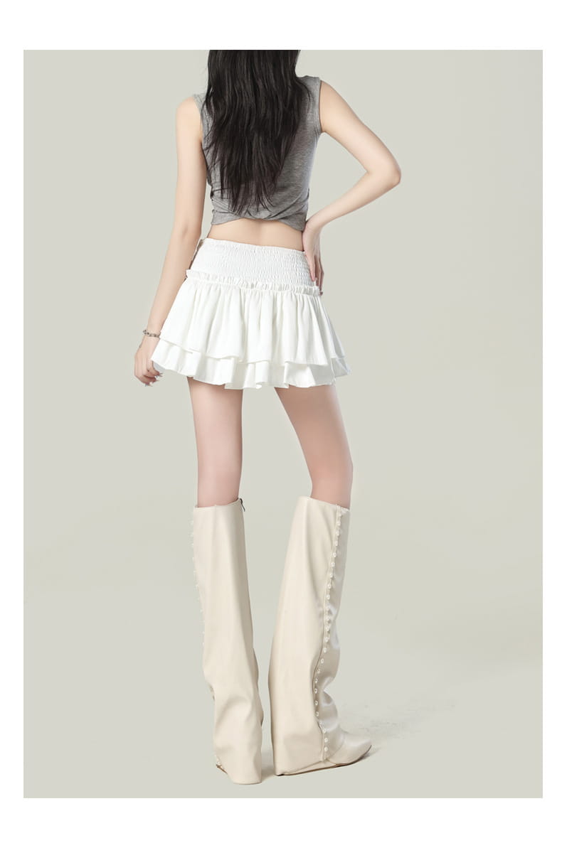 White tiered Y2k ruffled high waist mini skirt with elastic waistband designed for casual wear.