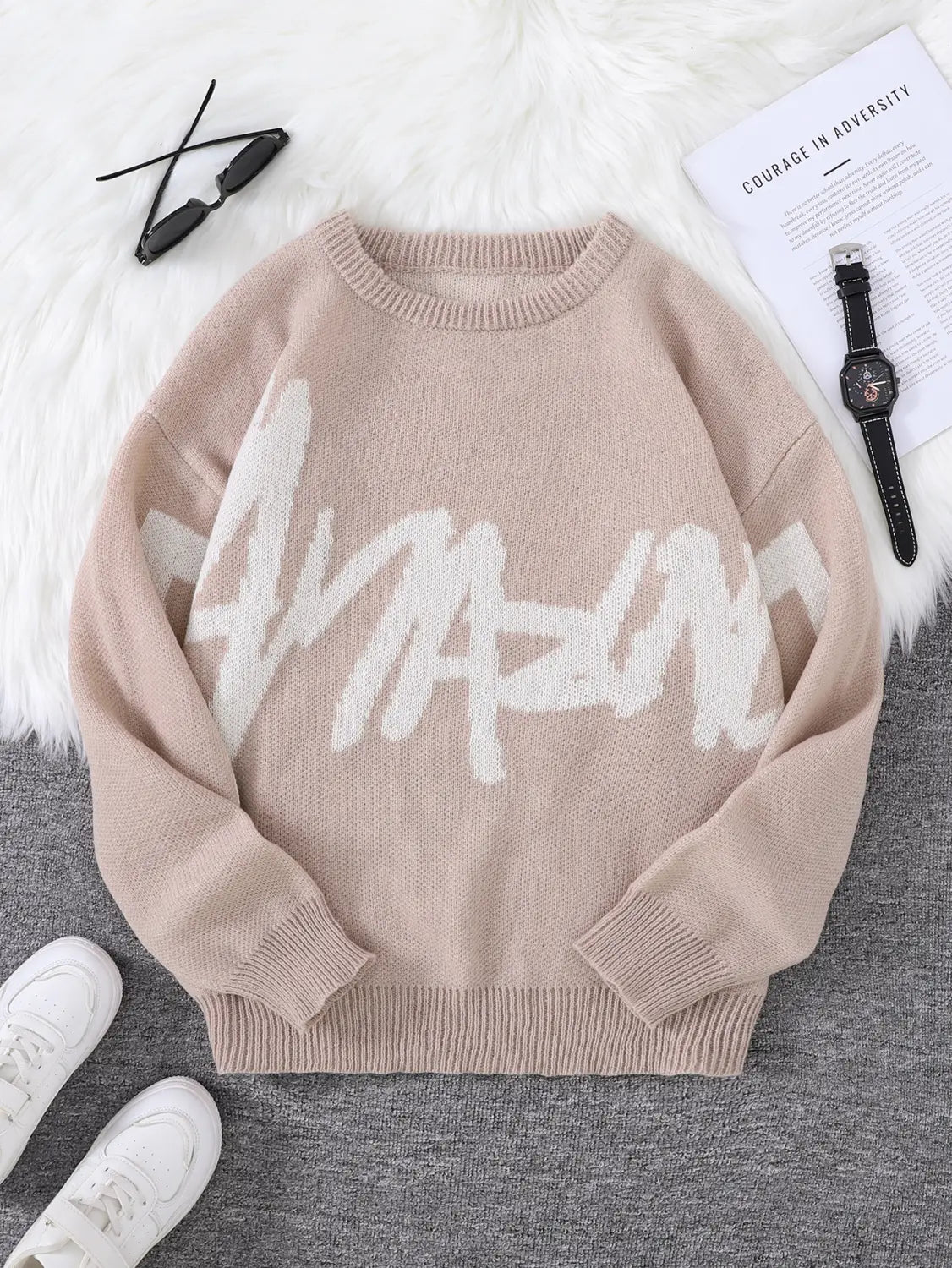 Men black amazing graphic knit sweater featuring a beige knit fabric with a bold white amazing graphic across the chest.