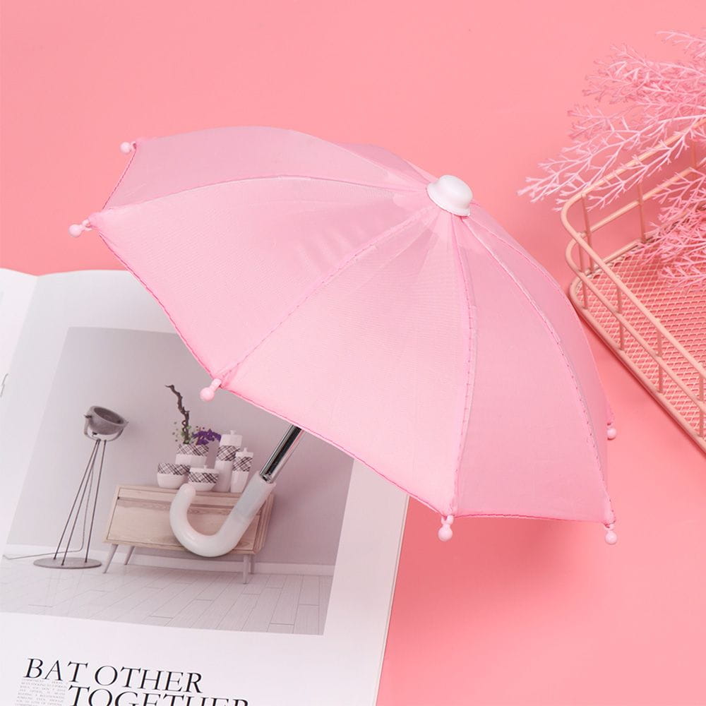 Pink mini doll umbrella with white handle and decorative pom-poms on the edges designed as BJD accessories.