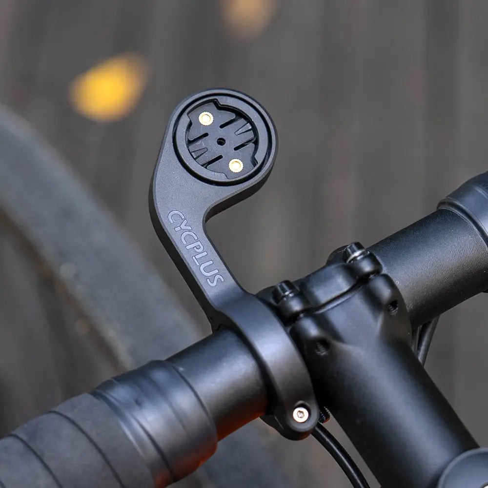 Black cyclops brand bicycle handlebar mount with circular mounting plate, two gold-colored screws, and integrated sensor interface for Cycplus Z1 outfront GPS bike computer.