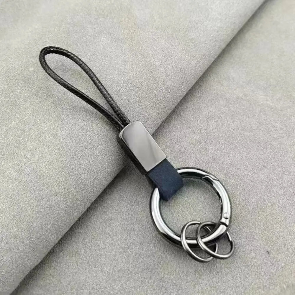 Black leather cord keychain with a sleek silver metal plate and interlocking rings designed as an anti-lost business key holder.