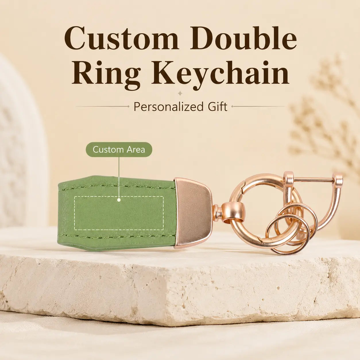 Personalized leather keychain featuring a green leather double ring design with rose gold metal accents and a customizable engraving area.