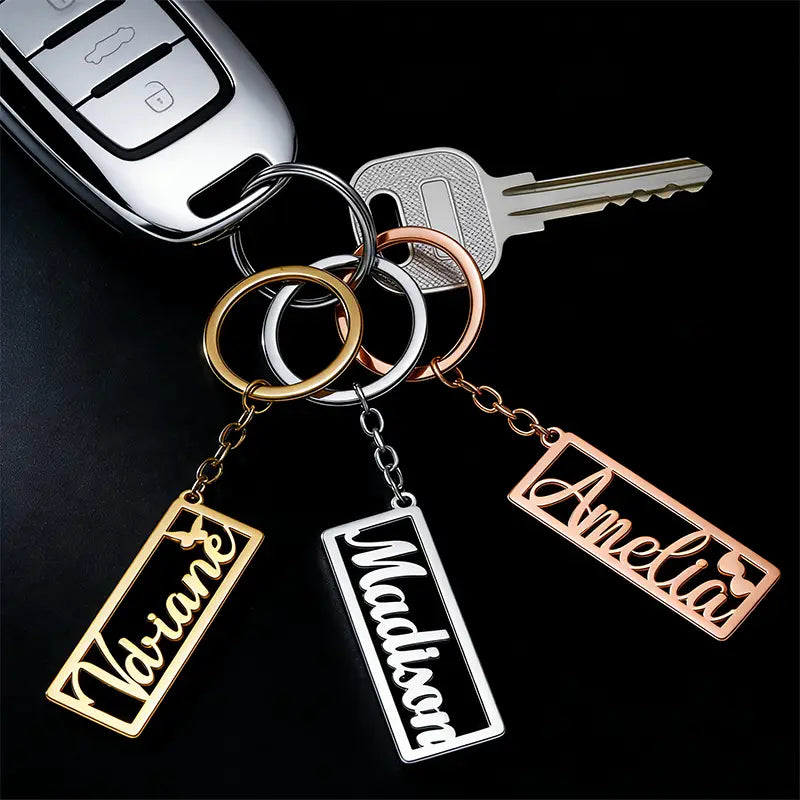 Custom name stainless steel keychains in gold silver and rose gold finishes personalized with names hang from a set of keys.