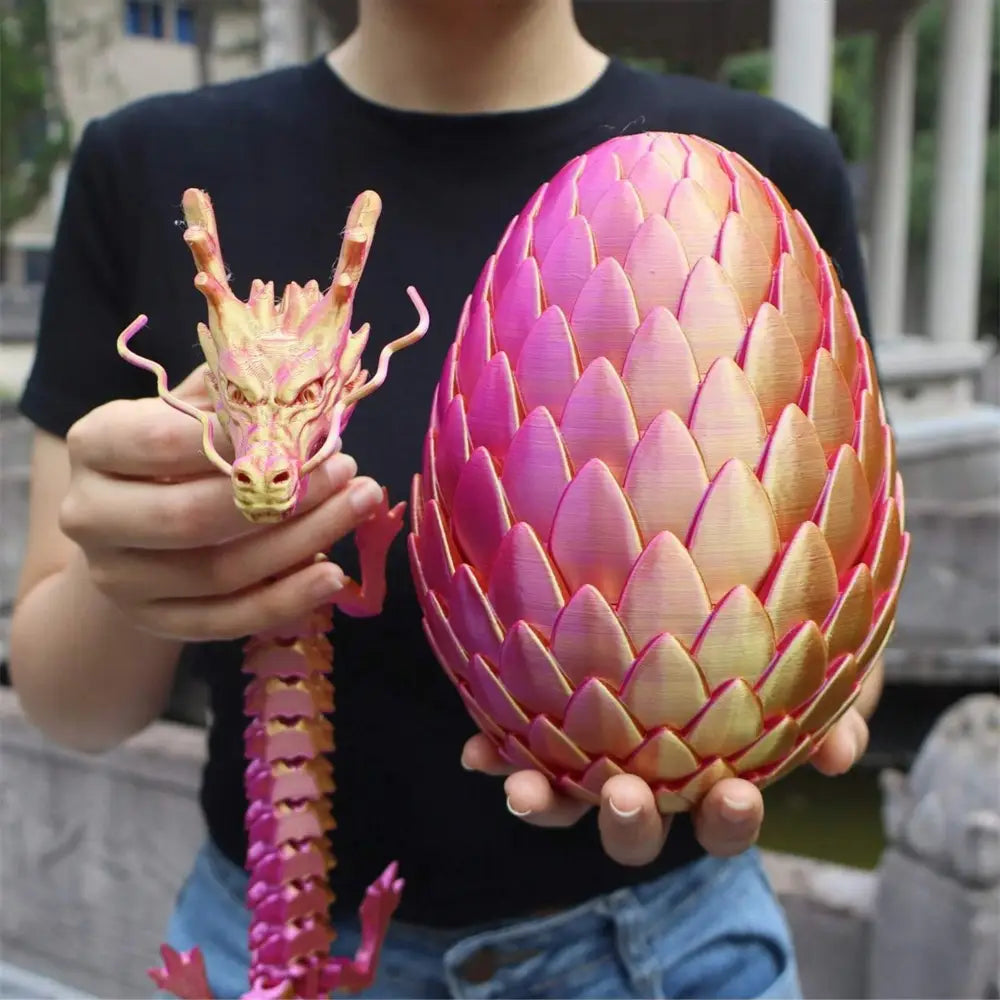 A vibrant pink and gold 3d printed giant dragon egg with a textured scaly surface shown from the front.