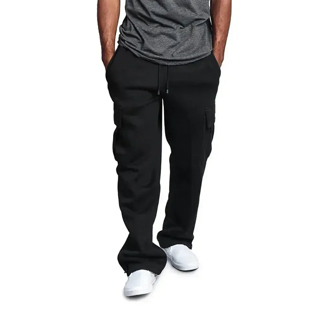Pantalons cargo noirs pour homme, à coupe ample de style jogging, avec des poches latérales et une ceinture à cordon de serrage.