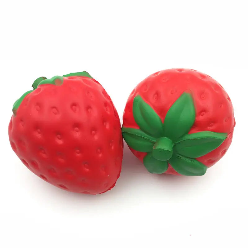 Juguete antiestrés de fresa gigante, que se eleva lentamente y es blandamente esponjoso, hecho de silicona suave, de color rojo, con hojas verdes en la parte superior, con forma de bolas antiestrés.