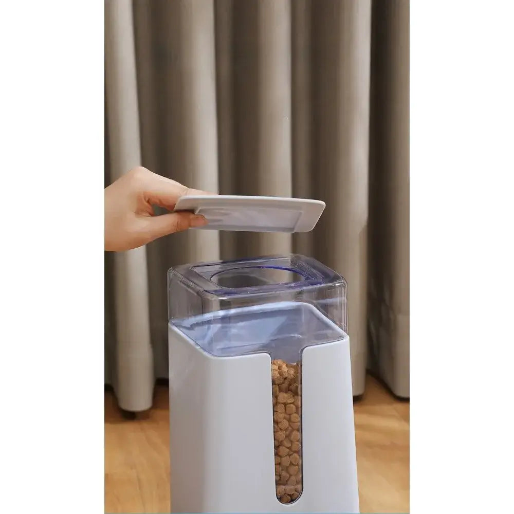 white plastic automatic pet feeder with transparent front panel and blue accents for pet food dispensing and 3.5 liter capacity