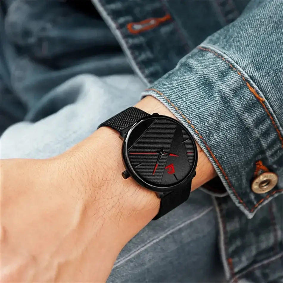 Herrenarmbanduhr aus schwarzem Mesh, Quarz, mit einem eleganten schwarzen Zifferblatt: rote Akzente und minimalistische Stundenmarkierungen.