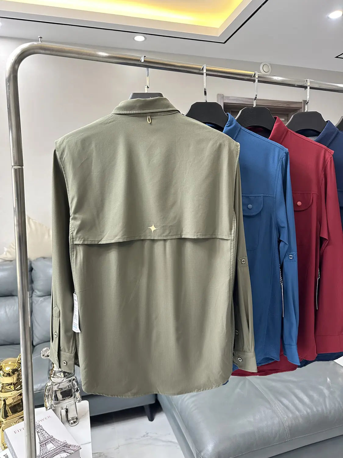 Men’s tactical outdoor long sleeve olive green shirt showing the back with a subtle star-shaped detail.
