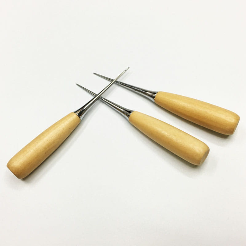 Set of three leather sewing awl craft punch tools with wooden handles and polished metal tips for leatherwork.