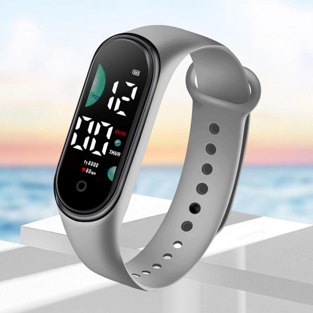 Gray silicone electronic watch with large font screen displaying time, date, and heart rate, designed as a waterproof digital sports watch.
