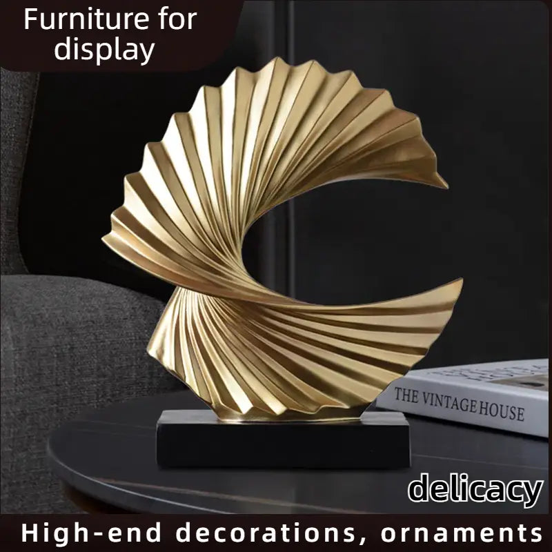 art deco gold wave sculpture tabletop decor featuring a golden fan-shaped abstract design with a sleek metallic finish and elegant curved details
