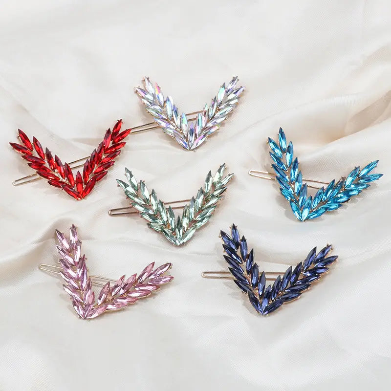 Crystal v shape hair clip set featuring v-shaped hair clips adorned with sparkling rhinestones in vibrant red silver blue pink and purple hues.