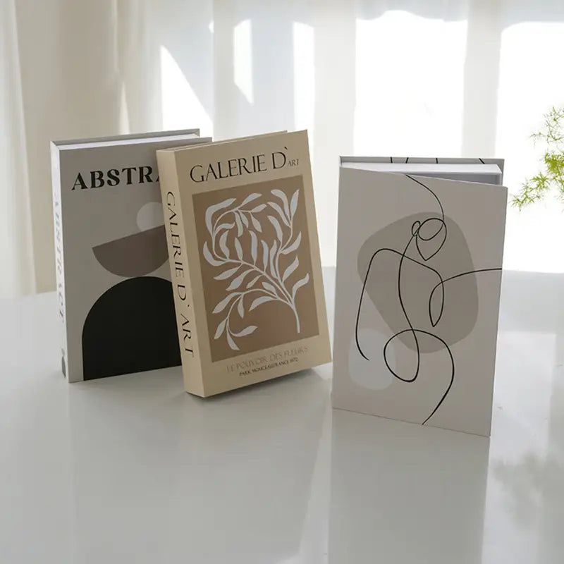Beige decorative fake book with white botanical illustration and galerie dart text on its spine for coffee table home decor.
