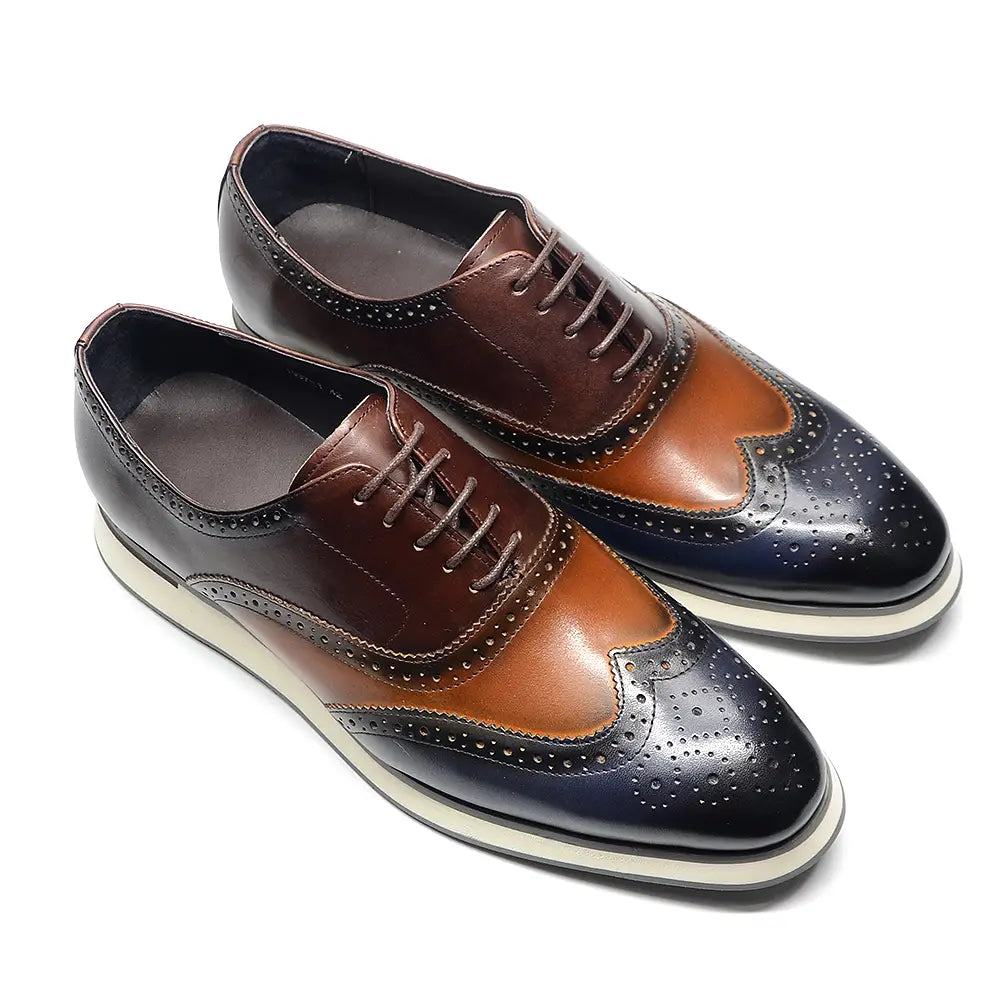 Escarpins brogue wingtip en cuir bicolore marron et noir, avec des détails ajourés.