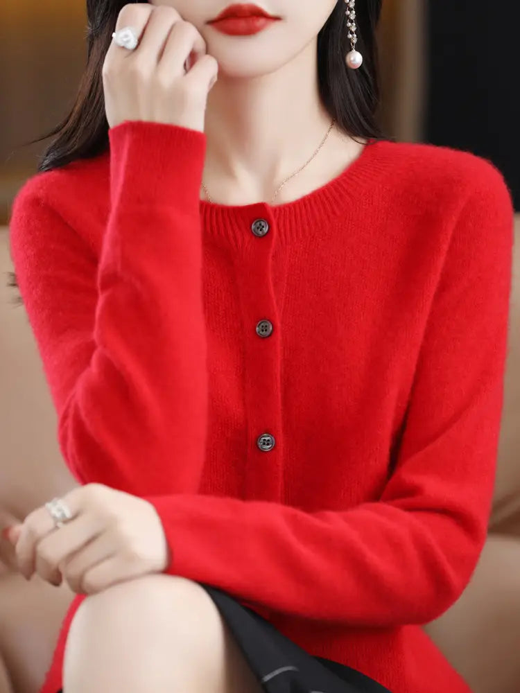 Vibrant red long-sleeved merino wool cardigan for women featuring a round neckline and dark metallic buttons.