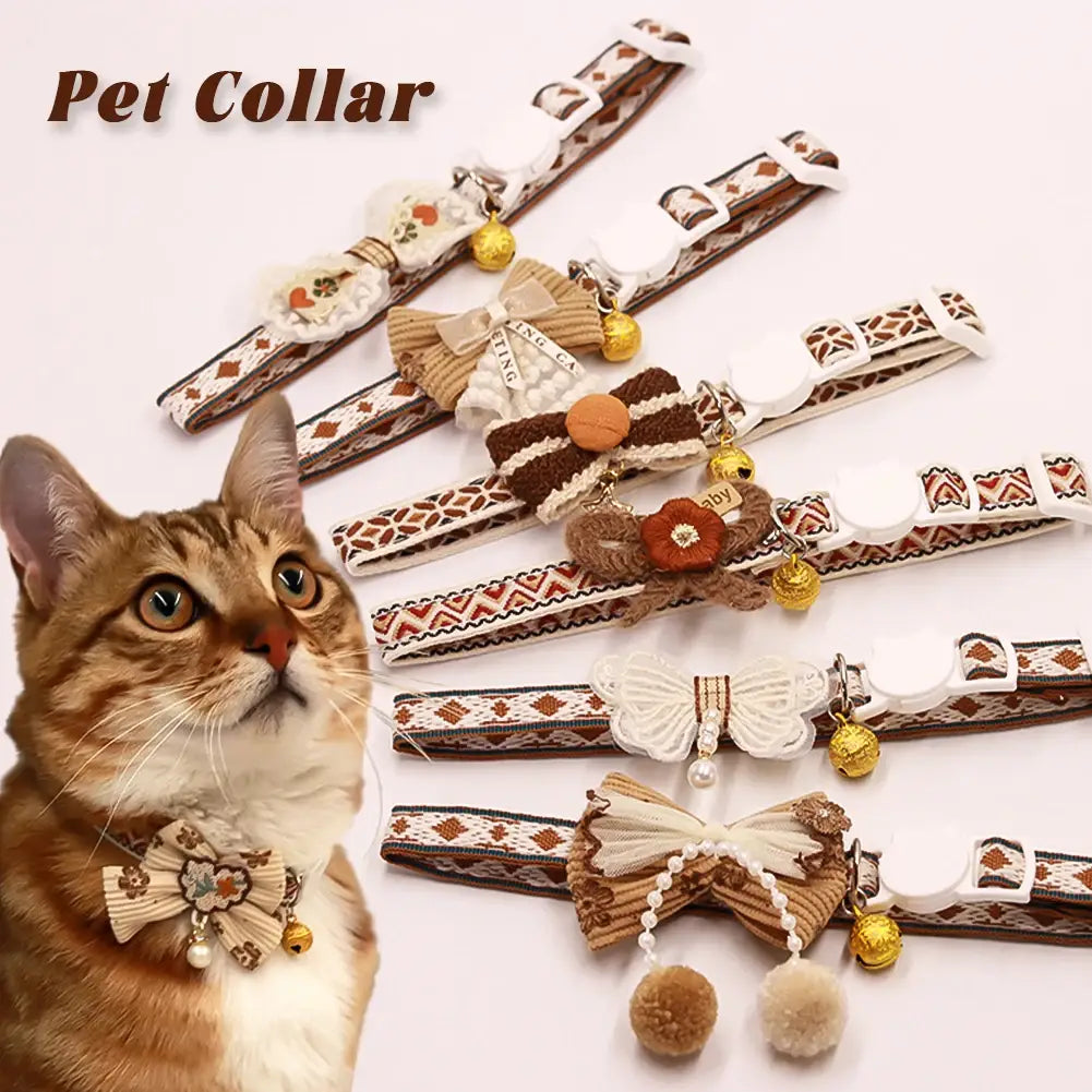 A charming brown and cream patterned adjustable length floral cat collar adorned with decorative bows beads and pom-poms with bell.