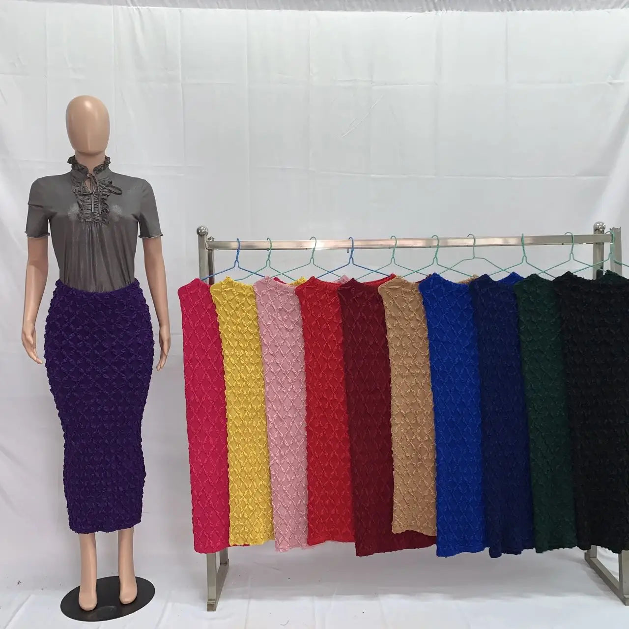 Purple textured high waist knit midi skirt with slim fit displayed on a mannequin