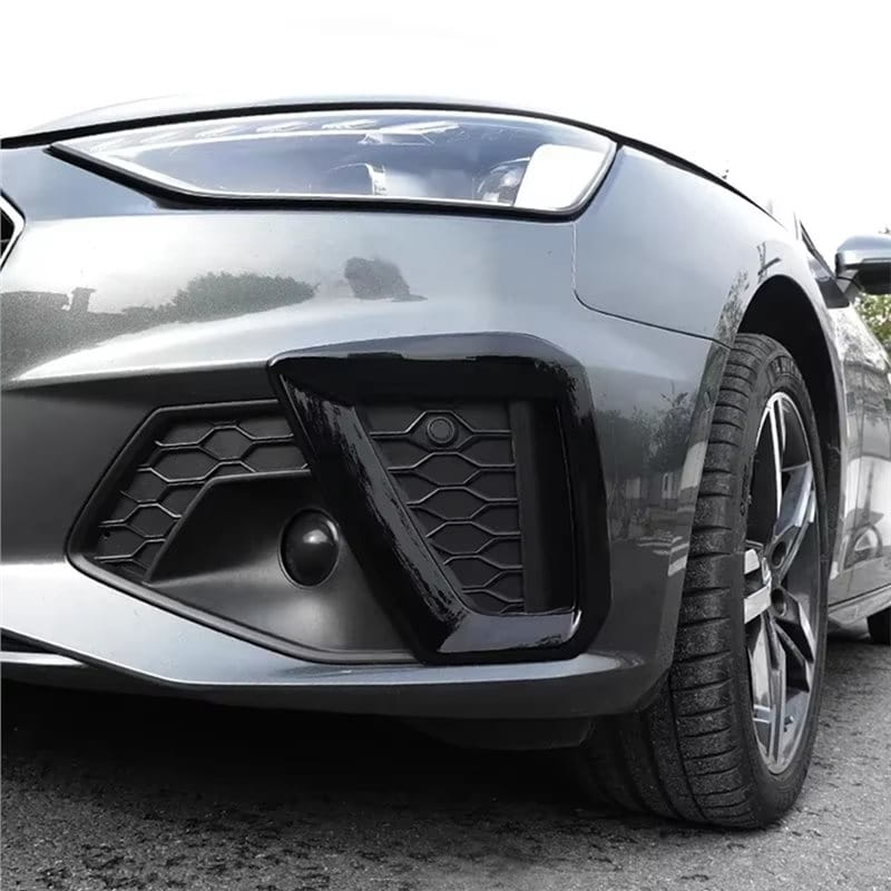 Audi A4 B9 fog lamp cover 2020 2024 featuring a black glossy plastic front air intake grille with hexagonal mesh pattern and integrated circular sensor.