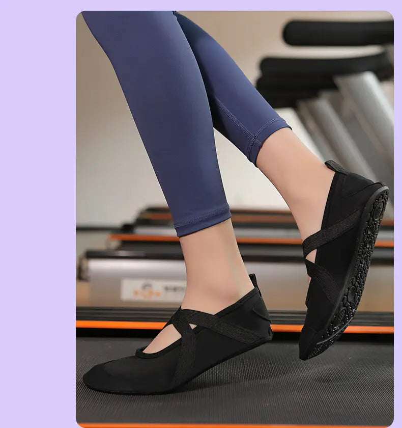 black mesh women yoga shoes with crisscross straps and textured rubber anti-slip soles designed for fitness flats.