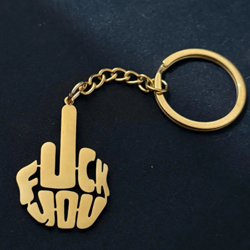 Gold-colored stainless steel custom logo keychain featuring a stylized middle finger design with bold cut-out lettering spelling fuck you.