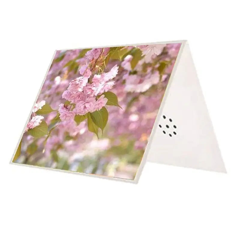 a white triangular recordable voice greeting card speaker with a printed image of pink cherry blossoms and green leaves on the front panel designed for DIY wedding audio messages.