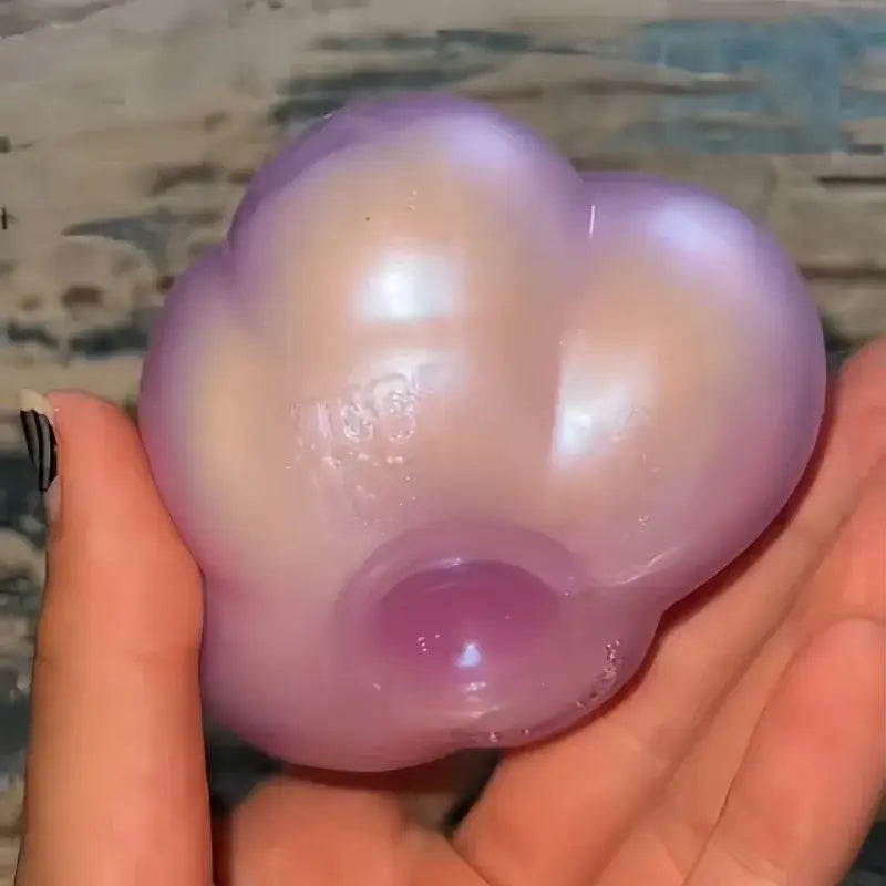 a translucent lavender cloud-shaped stress ball with a glossy finish and subtle iridescent sheen shown from the front, representing the needoh cloud pleaser slow rising squishy toy