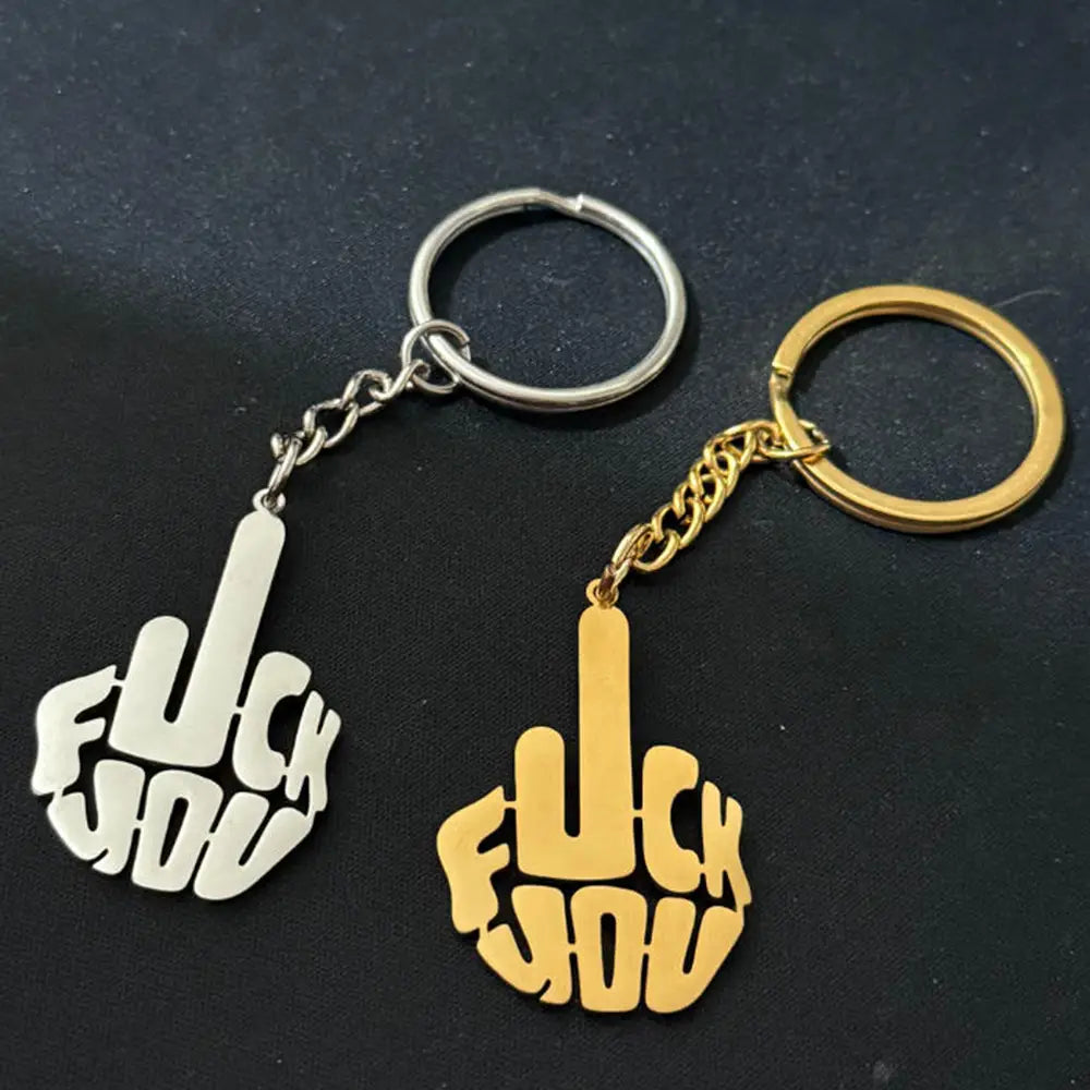 Two custom stainless steel logo keychains in silver and gold featuring hand gestures with the words fuck you cut out in bold lettering.
