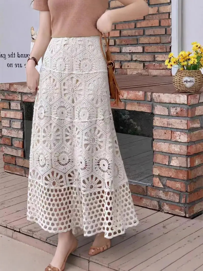 A flowing off-white crochet lace maxi skirt featuring intricate circular and hexagonal lace patterns, perfect for summer wear.