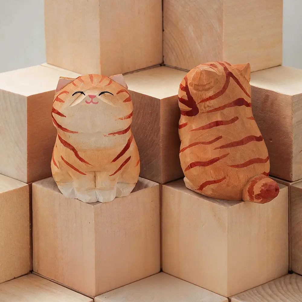 handcrafted wooden cat figurine desk decor showing two warm orange and cream hand carved cats with one facing forward smiling and one showing factory direct actual product back side with striped markings