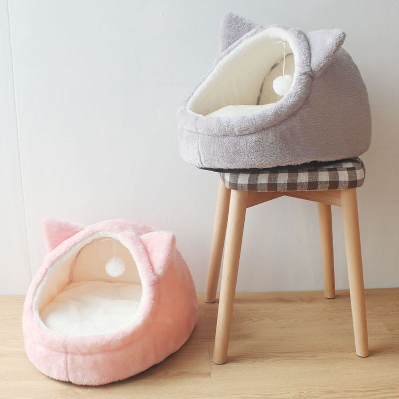 Foldable plush pet cave beds for small dogs and cats in gray and pink with soft fuzzy exteriors and white interiors shaped like cats.