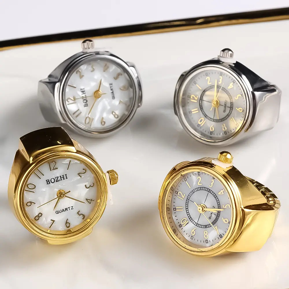Bozhi brand ring watch quartz finger jewelry featuring gold and silver-toned metal casings with pearl-like white faces and black leather straps designed as a unisex gift.