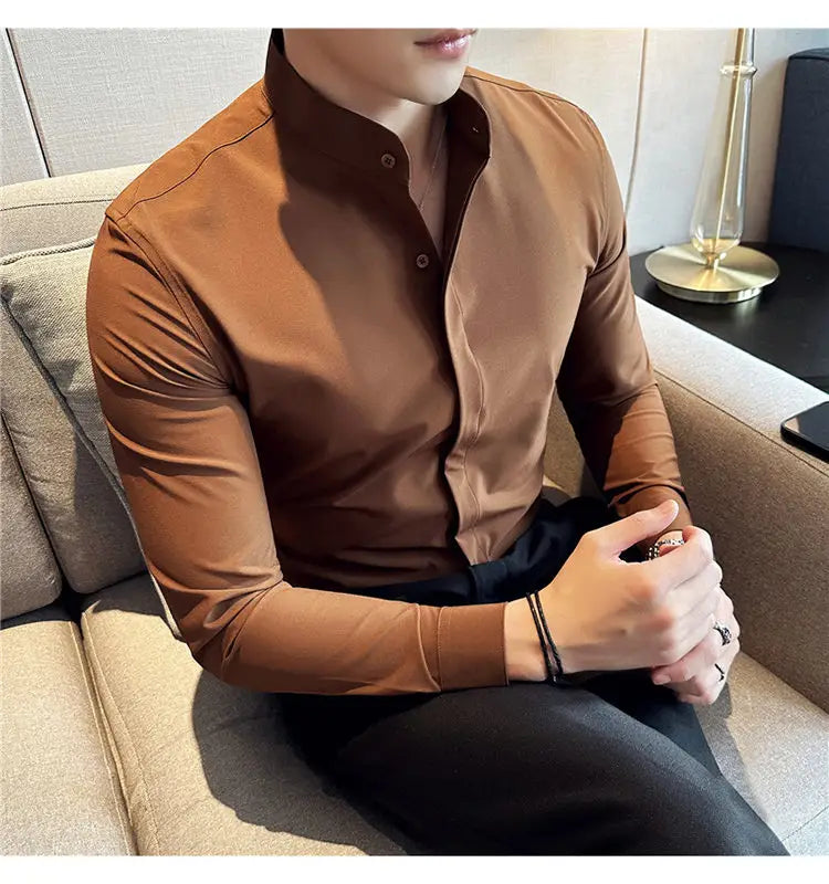 A sleek brown slim fit men dress shirt with a modern stand collar and subtle stitching details designed for a formal look and correct size fit.