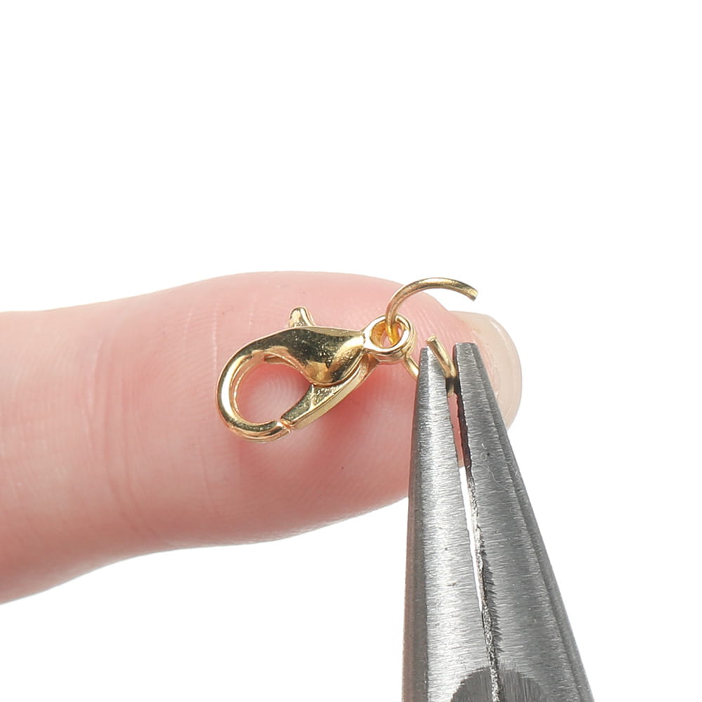 gold-toned metal lobster clasp with a small loop at the top included in a diy jewelry making findings kit with tools for crafting accessories.