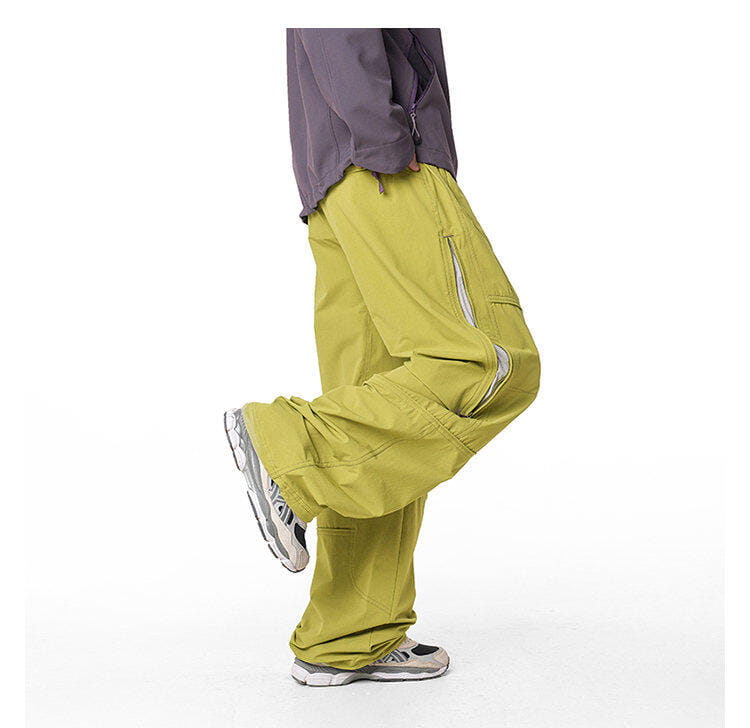 pantalones cargo impermeables de senderismo para hombre en verde oliva, con múltiples bolsillos y detalles de cremallera, diseñados para un rendimiento de secado rápido.