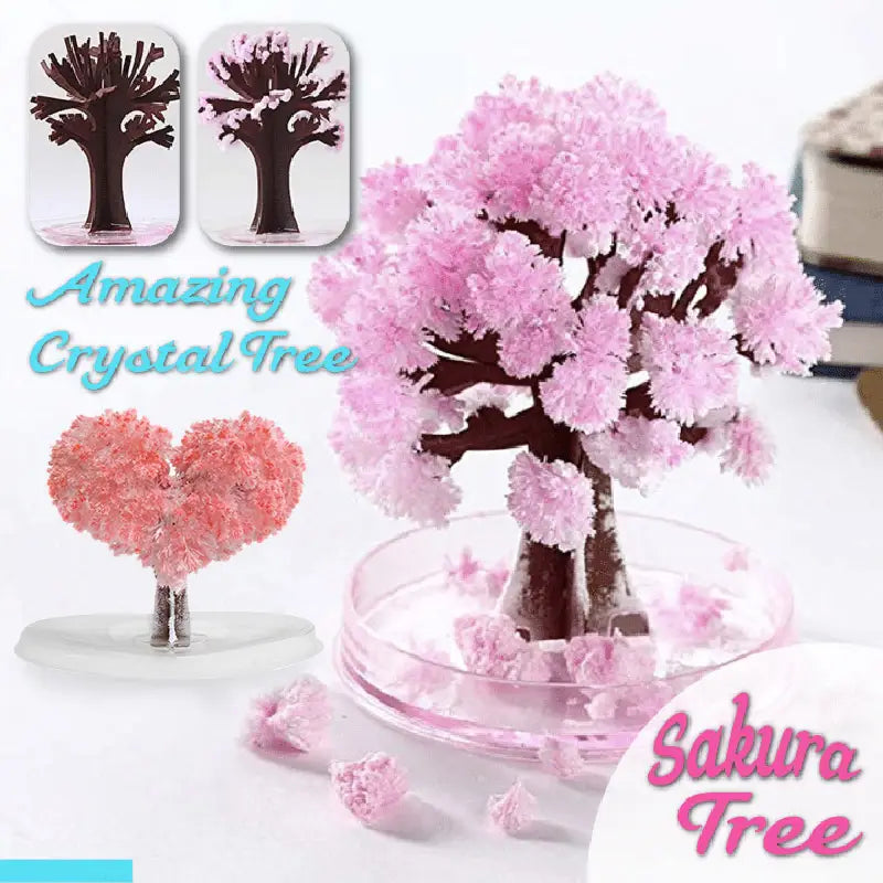 Magic growing Christmas tree crystal tabletop toy featuring a pink crystalline sakura tree with a dark brown trunk displayed in a clear glass dish.