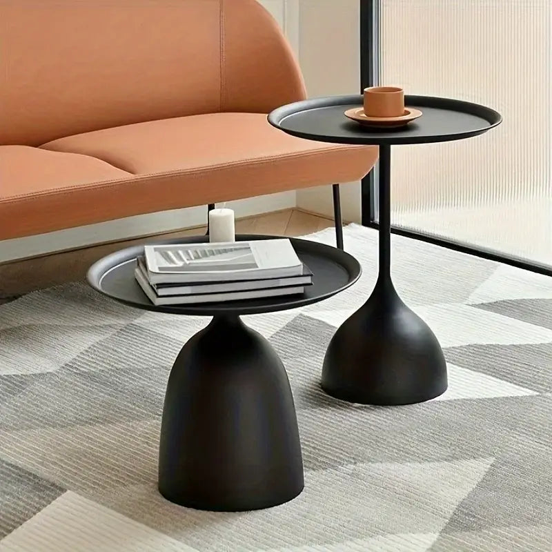 Black matte-finished modern coffee table with round living room side tables featuring sleek tulip-shaped bases and circular tops.