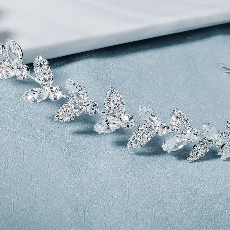 A delicate silver-toned crystal leaf bridal headband adorned with clear faceted crystal butterflies and leaf motifs for wedding hair accessory.