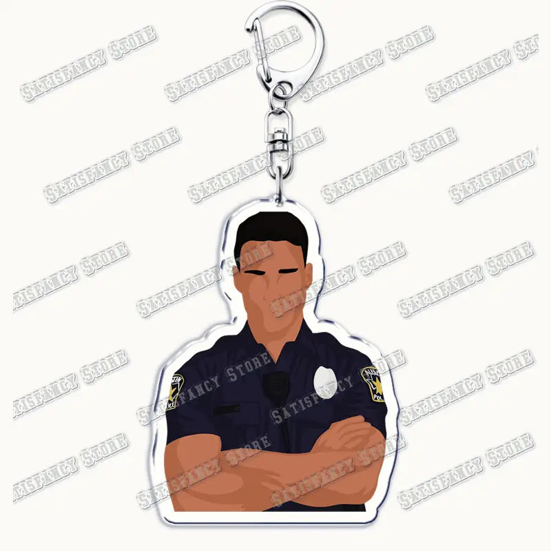 A clear acrylic 9-1-1 TV show keychain featuring a stylized illustration of a police officer in a dark blue uniform with crossed arms and a silver metal clasp, ideal as a firefighter gift.