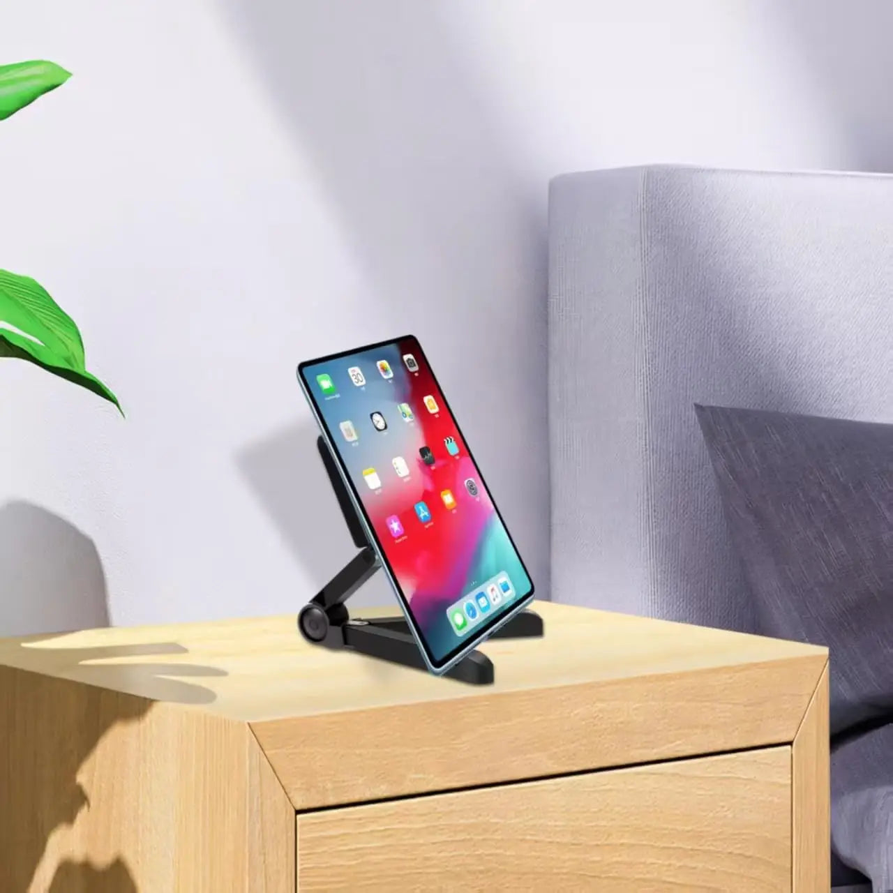 black foldable tablet phone stand adjustable desk holder made of durable material holding a smartphone on a wooden surface for use as a portable monitor or tablet phone stand