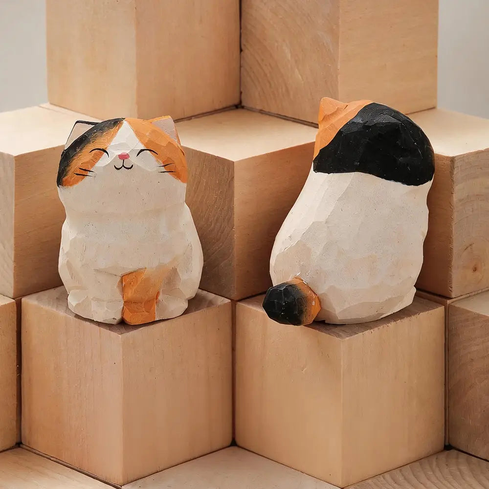 Handcrafted wooden cat figurines with painted orange black and white markings serve as charming desk decor and represent an actual product available factory direct.