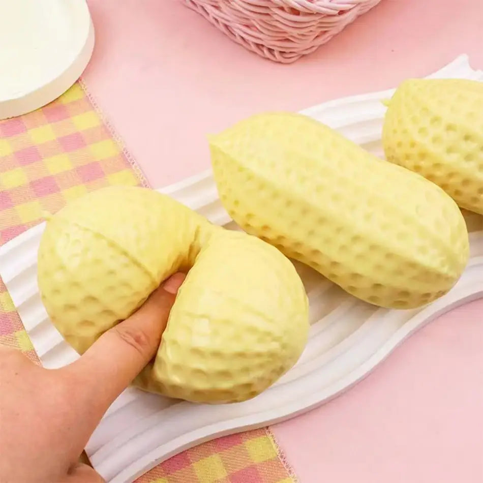 yellow peanut squishy filled stress toy with a textured dotted surface made of soft squishy material for stress relief.