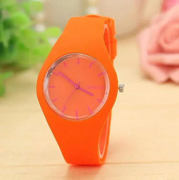 Montre à quartz pour femmes Genève en silicone orange vif, cadran assorti et marqueurs des heures roses, conçue pour un usage vestimentaire décontracté.