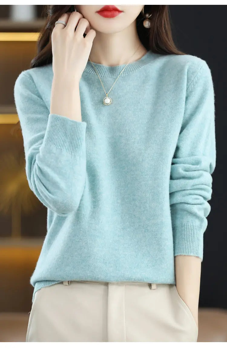 A soft light blue pure wool cashmere o-neck pullover sweater with a round neckline and ribbed cuffs.