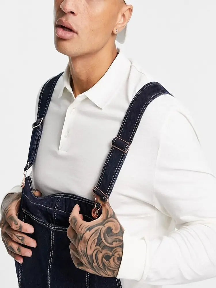 Men denim overalls loose casual bib jeans in dark blue denim with contrasting white stitching and adjustable shoulder straps.