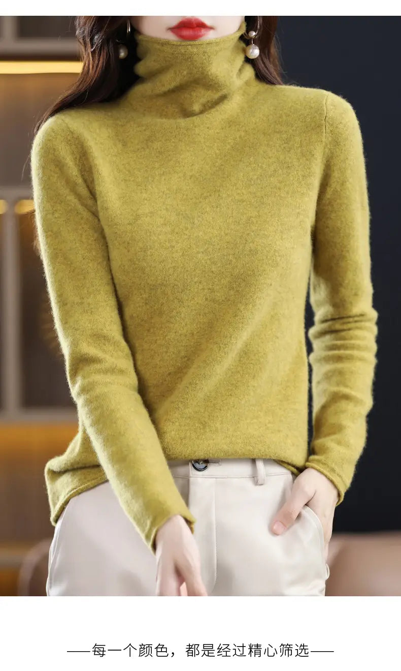 A soft olive green merino wool turtleneck sweater for women with a fine knit texture and long sleeves.