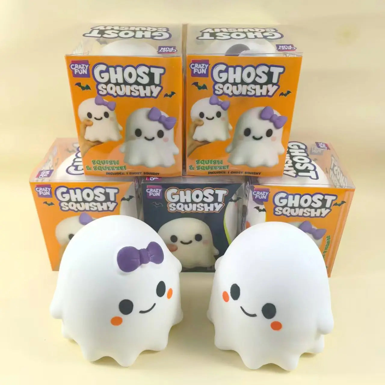 white ghost squishy slow rising stress relief toys with purple bows and orange cheeks packaged in colorful boxes