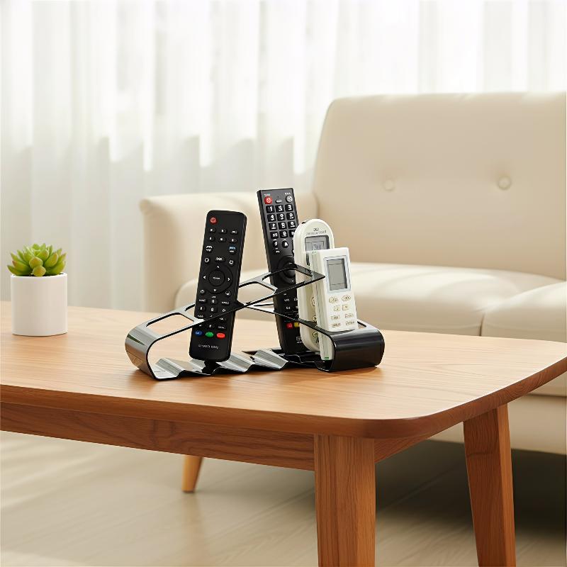 Black metal remote control organizer desktop storage rack holding three remotes for efficient home or office use.